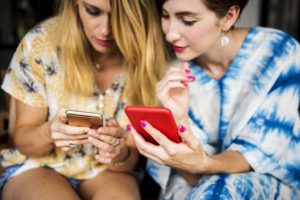 women looking at their phones