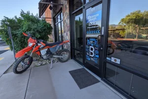 A red motorbike parked outside the BPetersonDesign door in Cave Creek.